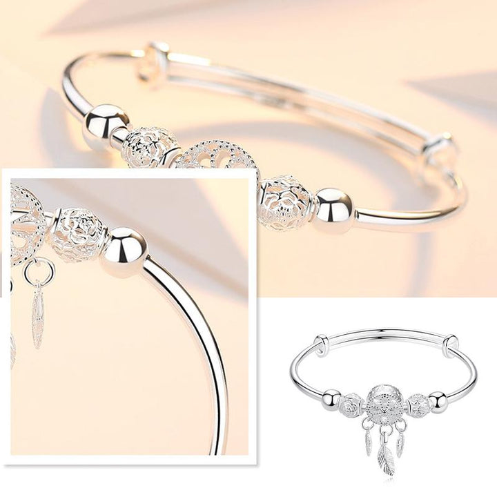 "Dreamcatcher Armband i silver för män och kvinnor, justerbart, med glansig finish och unikt drömfångarmotiv."