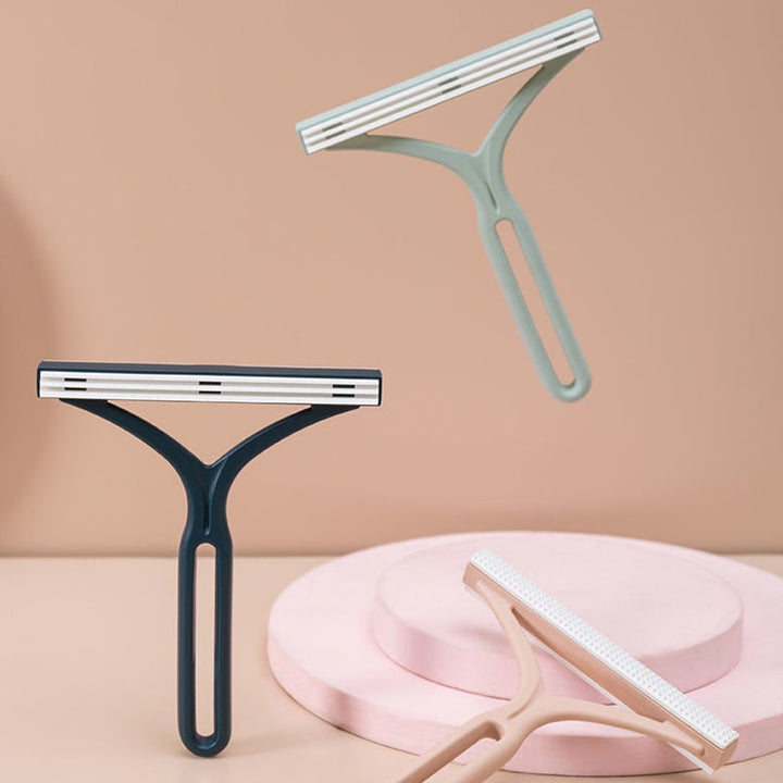 "Dubbelsidig manuell hårborttagningsapparat för kläder med ergonomiskt Y-handtag, silikonborste, grön, blå och rosa."