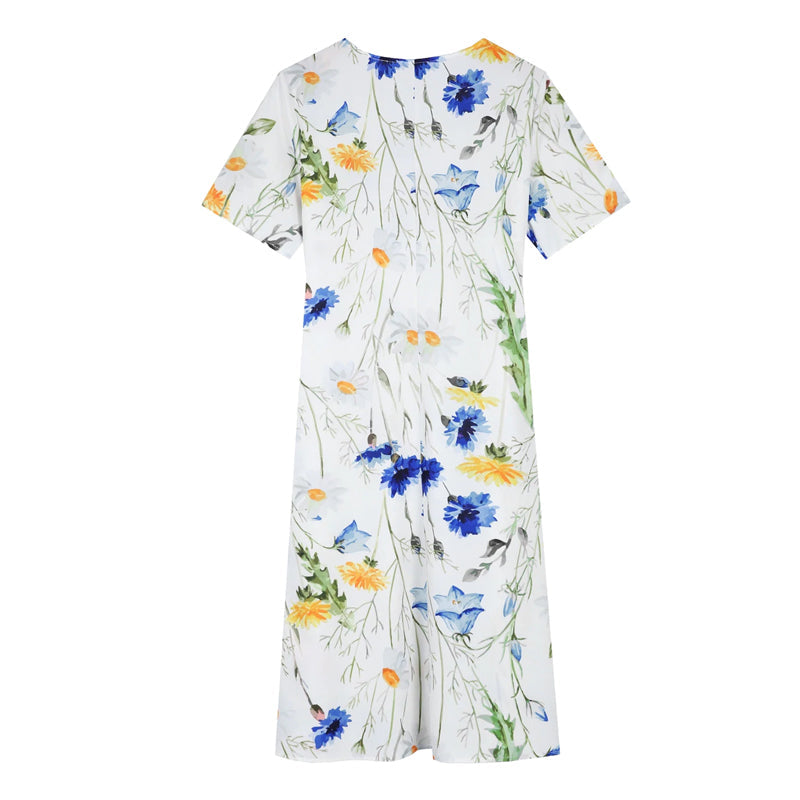 "Elegant blommig A-linje sommarklänning med rund hals i vitt, blått och gult, perfekt för sommardagar och fester."