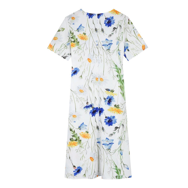 "Elegant blommig A-linje sommarklänning med rund hals i vitt, blått och gult, perfekt för sommardagar och fester."