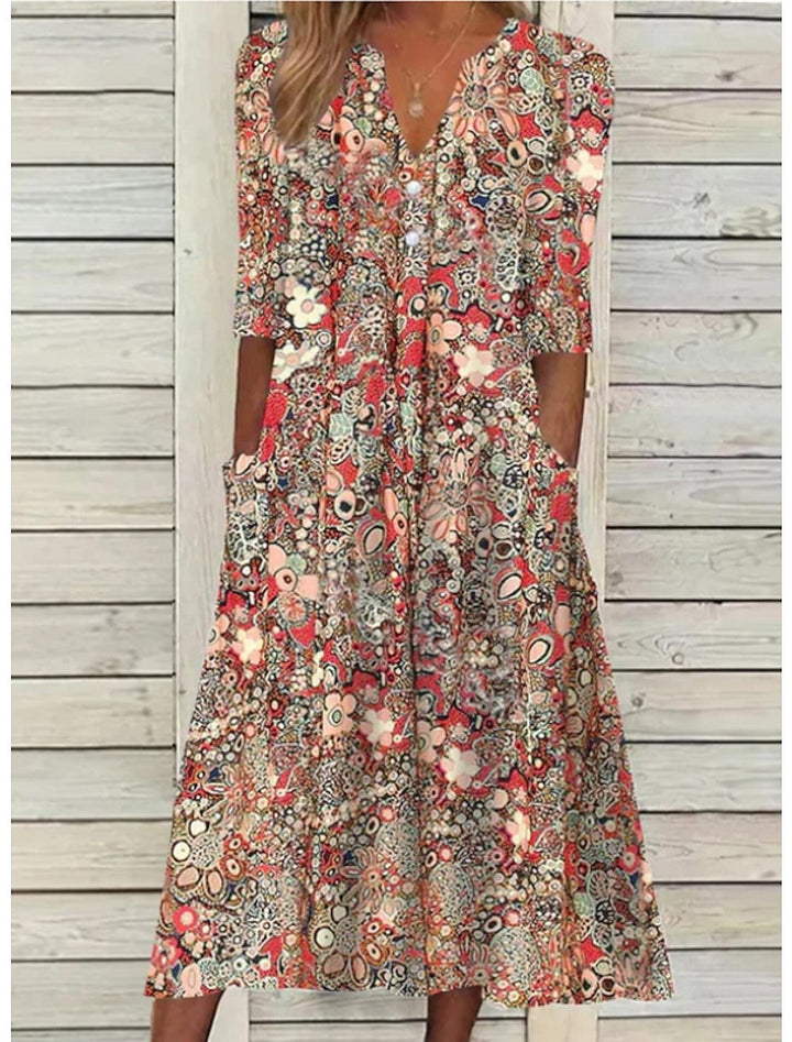 Elegant blommig damklänning med v-ringning och praktiska fickor, perfekt som sommarklänning eller vardagsklänning.