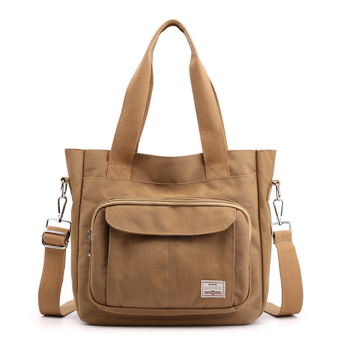 "Elegant crossbody-handväska i nylon för damer, svart och slitstark, kan bäras som axelväska, justerbar rem."