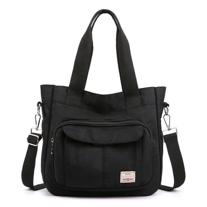 "Elegant crossbody-handväska i nylon för damer, svart och slitstark, kan bäras som axelväska, justerbar rem."