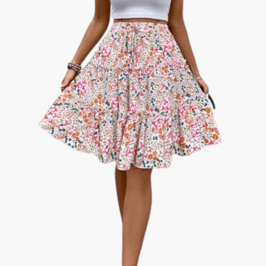 Elegant dam midikjol med elastisk midja, volangkant och A-linje. Perfekt för vår och sommar.