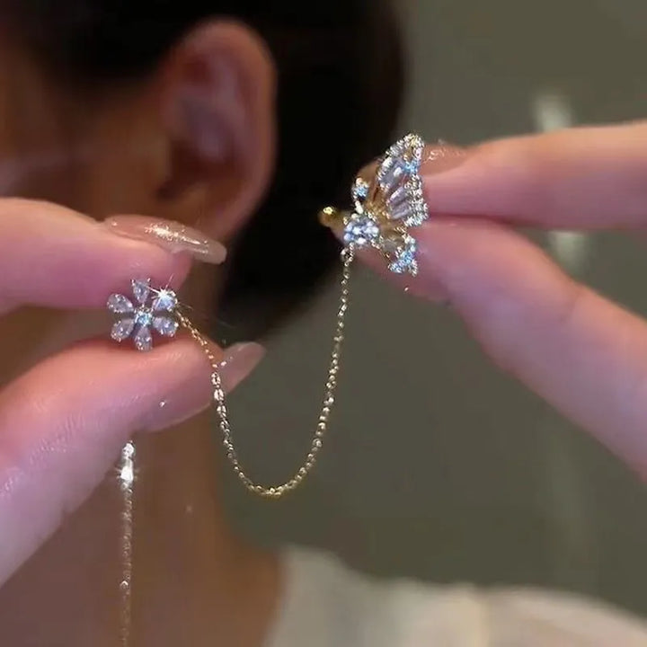 Elegant dam öroncuff med fjäril & blomma, guld/silver, strass. Unikt smycke utan piercing för fest/vardag.