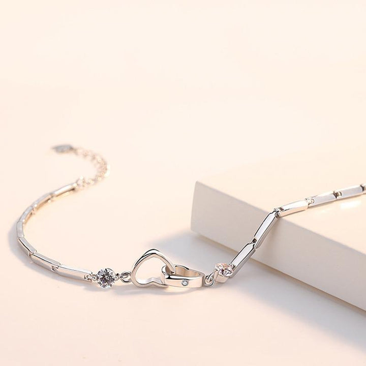 "Elegant damarmband med hjärtform i glittrande kristaller på rodiumpläterad kedja, perfekt som festligt smycke."