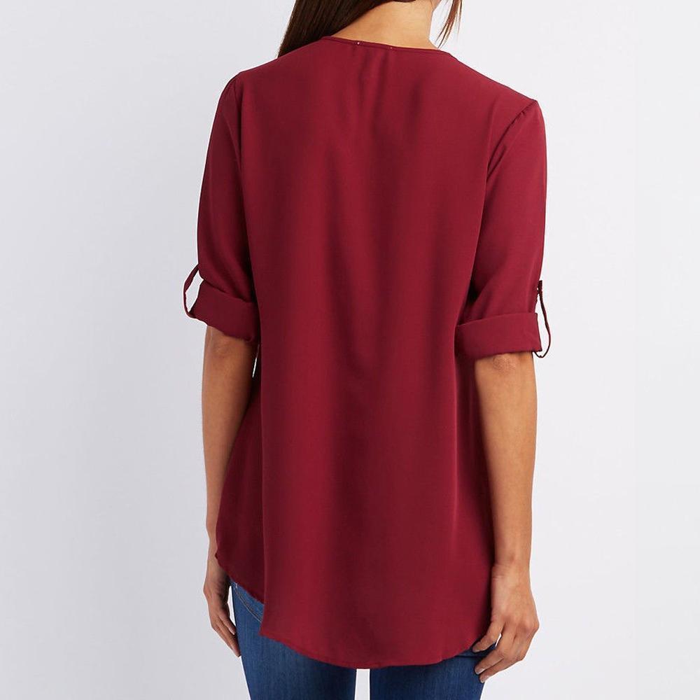 "Elegant damblusa med V-ringning och justerbar dragkedja, finns i flera färger; perfekt för stil och komfort."