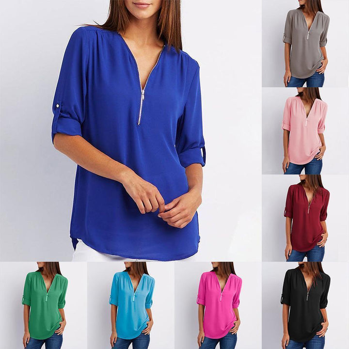 "Elegant damblusa med V-ringning och justerbar dragkedja, finns i flera färger; perfekt för stil och komfort."