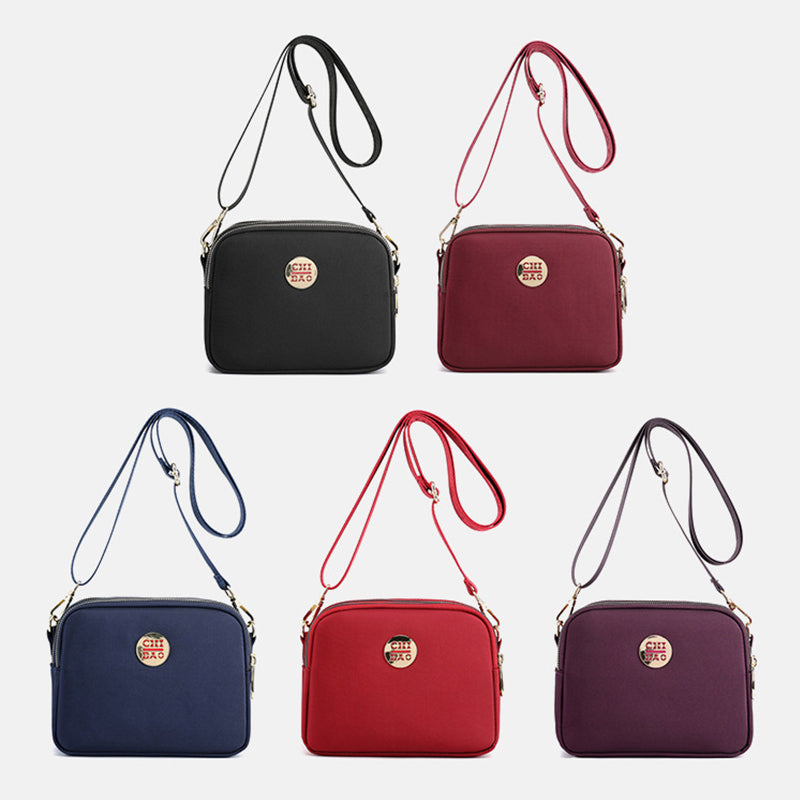 Elegant damers nylon crossbody kurirväska med multifickor, justerbar axelrem, tillgänglig i flera färger.