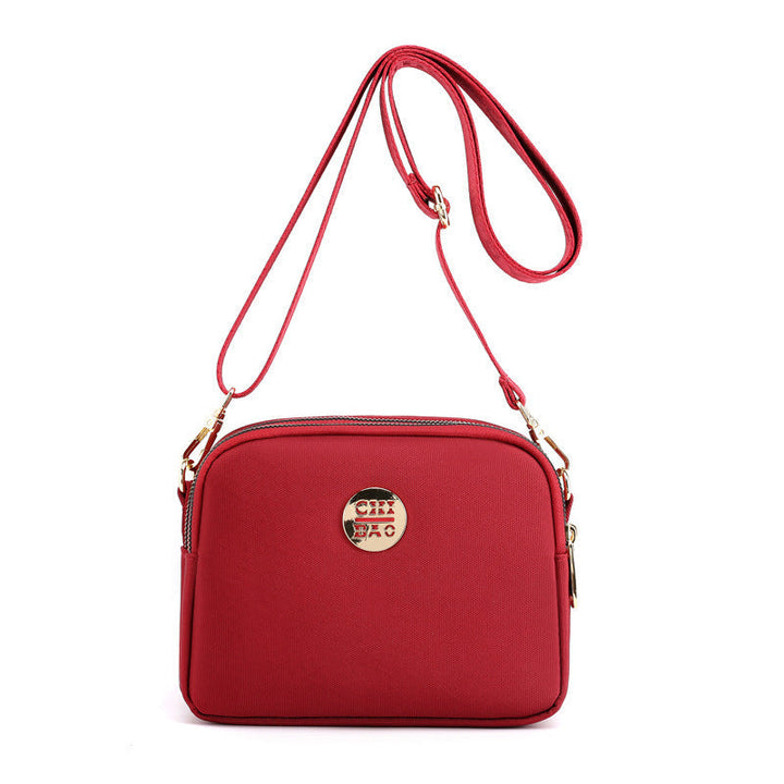 Elegant damers nylon crossbody kurirväska med multifickor, justerbar axelrem, tillgänglig i flera färger.
