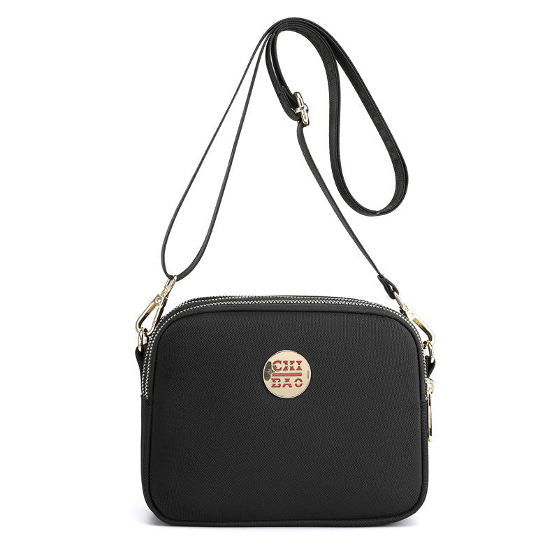 Elegant damers nylon crossbody kurirväska med multifickor, justerbar axelrem, tillgänglig i flera färger.