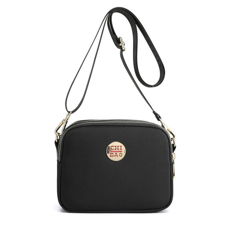 Elegant damers nylon crossbody kurirväska med multifickor, justerbar axelrem, tillgänglig i flera färger.