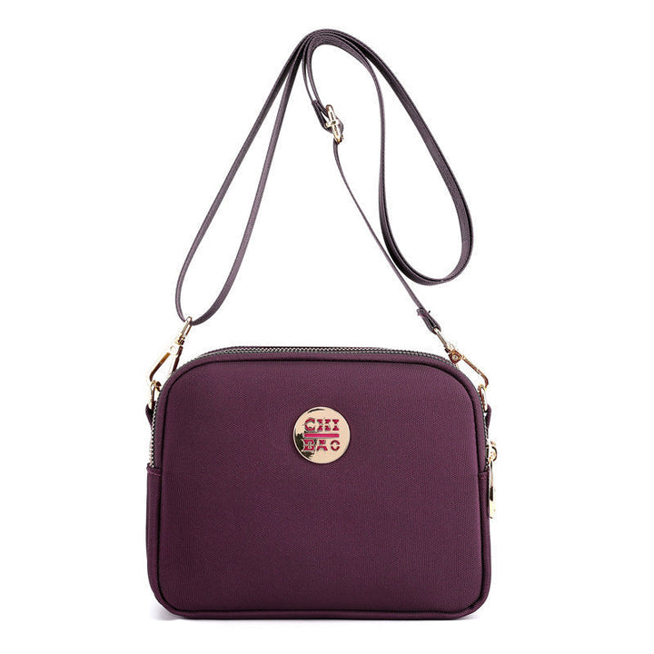Elegant damers nylon crossbody kurirväska med multifickor, justerbar axelrem, tillgänglig i flera färger.