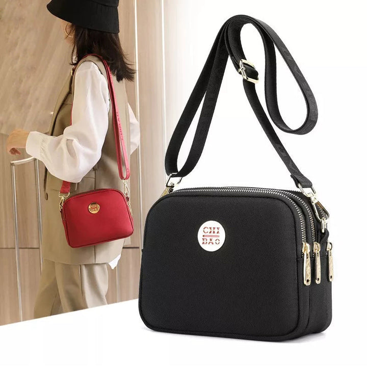 Elegant damers nylon crossbody kurirväska med multifickor, justerbar axelrem, tillgänglig i flera färger.