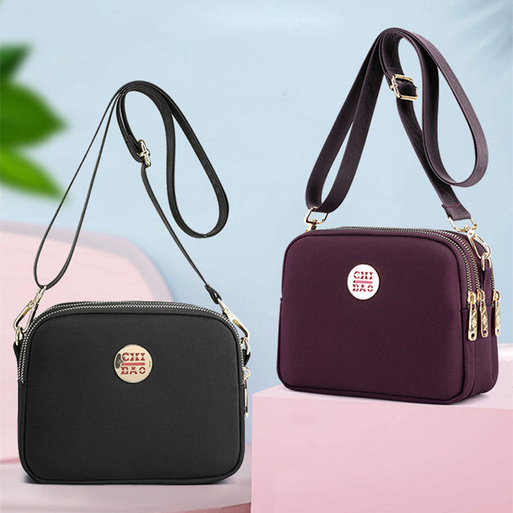Elegant damers nylon crossbody kurirväska med multifickor, justerbar axelrem, tillgänglig i flera färger.