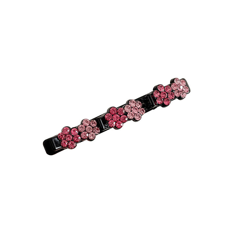 "Elegant damhårnål med strassblomma, handgjord i glittrande strass och harts, finns i rosa, lila, brun och grå."