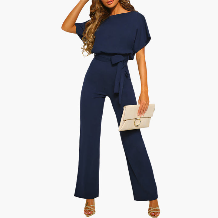 Damjumpsuit bakifrån. Elegant overall med breda, flödande ben. Kvällskläder för stilmedvetna kvinnor.
