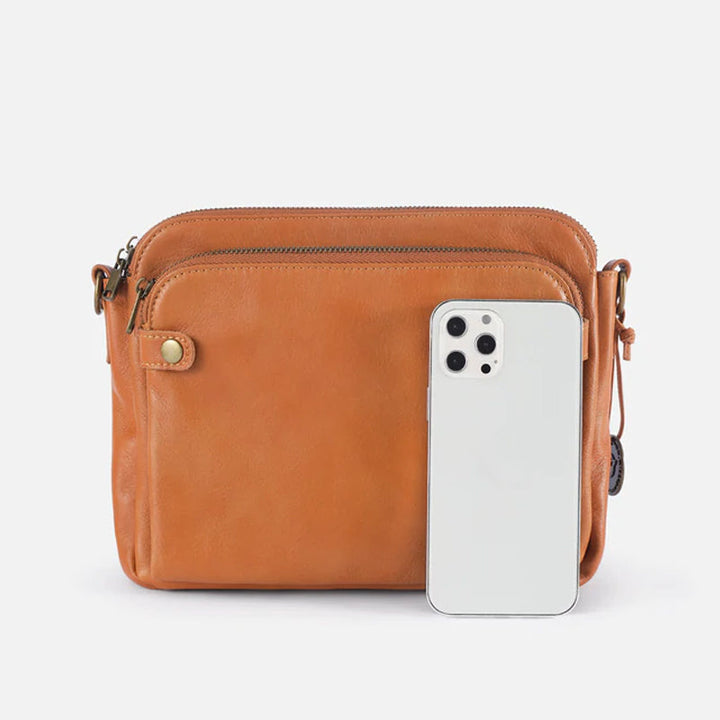 Elegant damläderväska crossbody med multifunktionell design, justerbara remmar och RFID-skydd i flera färger.