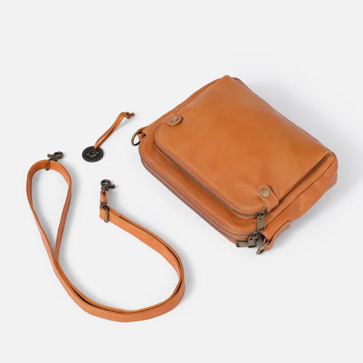 Elegant damläderväska crossbody med multifunktionell design, justerbara remmar och RFID-skydd i flera färger.