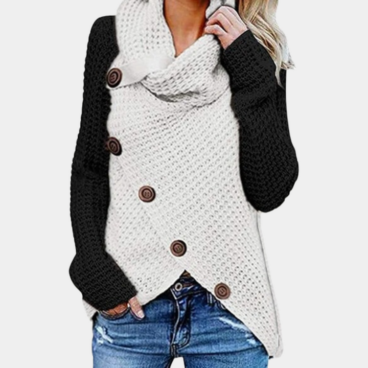 Elegant damtröja med asymmetrisk knappdetalj. Perfekt för chic höststil och värme.