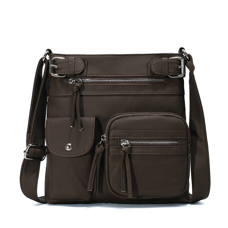 "Elegant damväska i veganskt läder, crossbody med flera fickor, vattentät och stilfull design för optimal organisation."