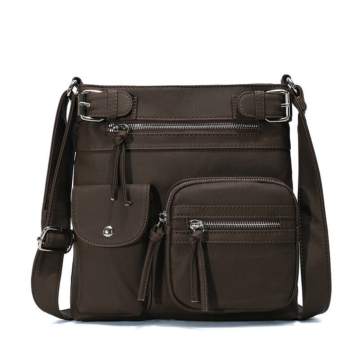 "Elegant damväska i veganskt läder, crossbody med flera fickor, vattentät och stilfull design för optimal organisation."