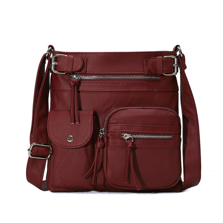 "Elegant damväska i veganskt läder, crossbody med flera fickor, vattentät och stilfull design för optimal organisation."