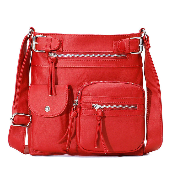 "Elegant damväska i veganskt läder, crossbody med flera fickor, vattentät och stilfull design för optimal organisation."