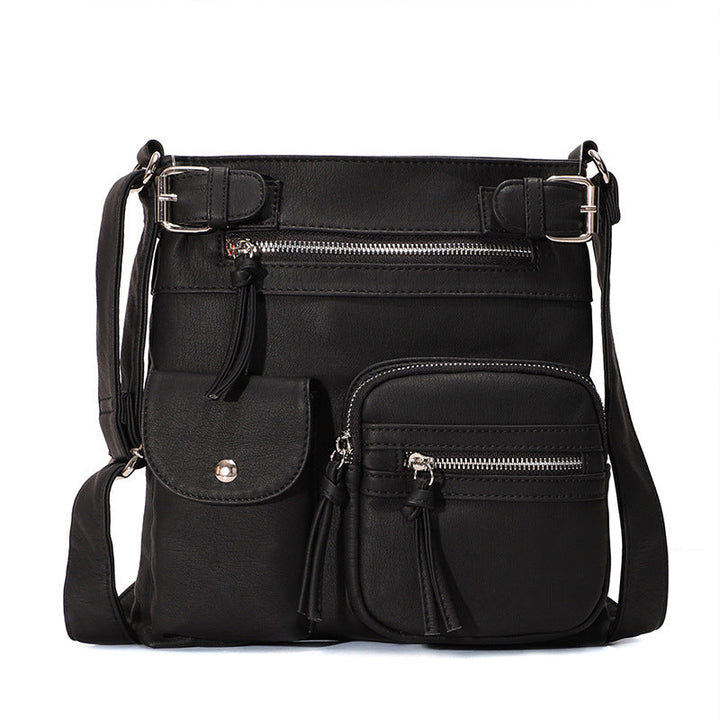 "Elegant damväska i veganskt läder, crossbody med flera fickor, vattentät och stilfull design för optimal organisation."