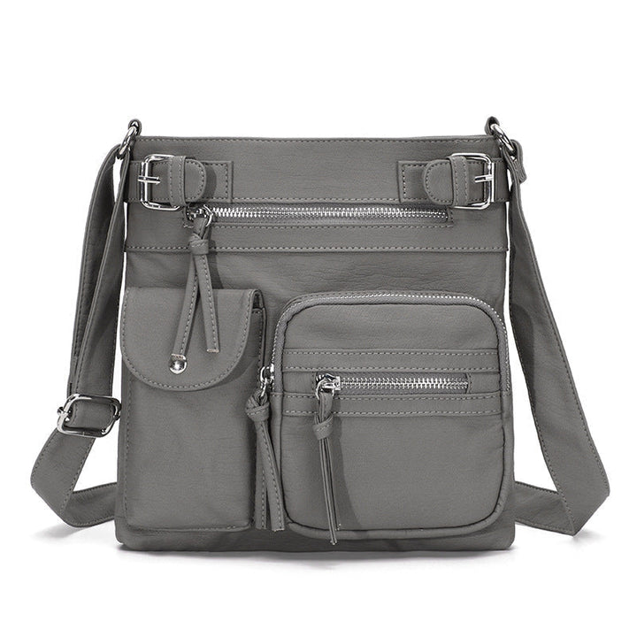 "Elegant damväska i veganskt läder, crossbody med flera fickor, vattentät och stilfull design för optimal organisation."
