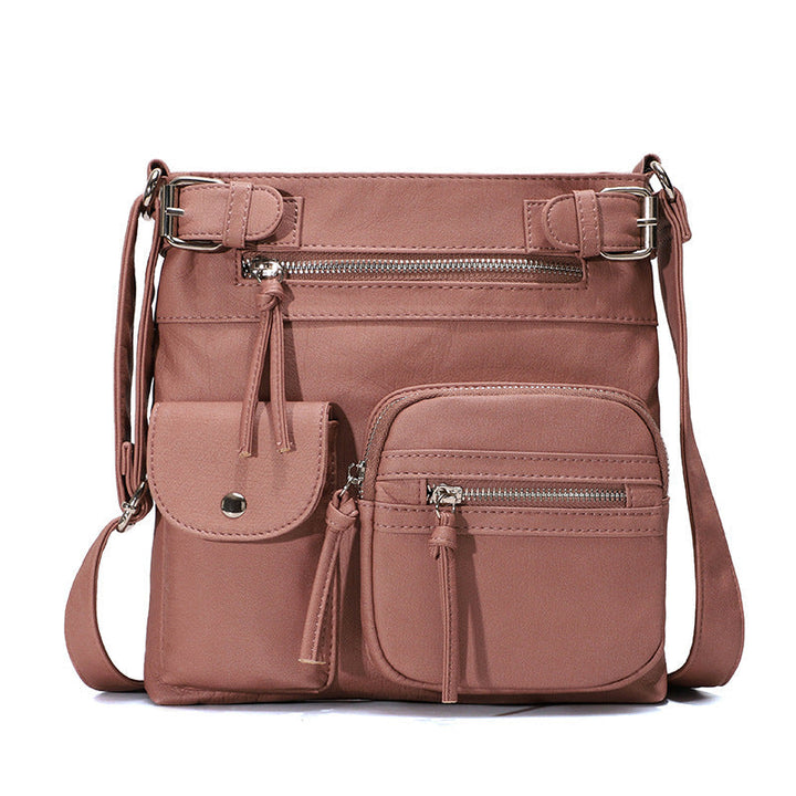 "Elegant damväska i veganskt läder, crossbody med flera fickor, vattentät och stilfull design för optimal organisation."