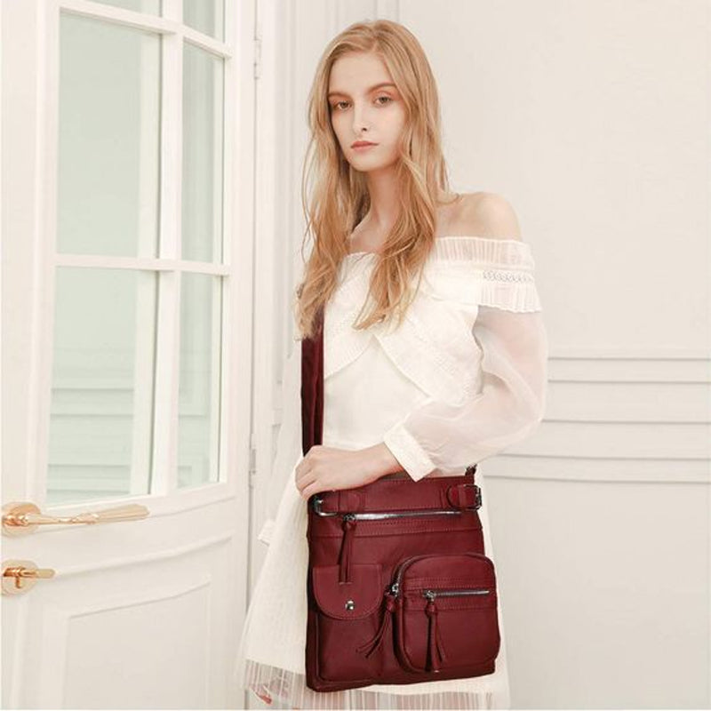 "Elegant damväska i veganskt läder, crossbody med flera fickor, vattentät och stilfull design för optimal organisation."