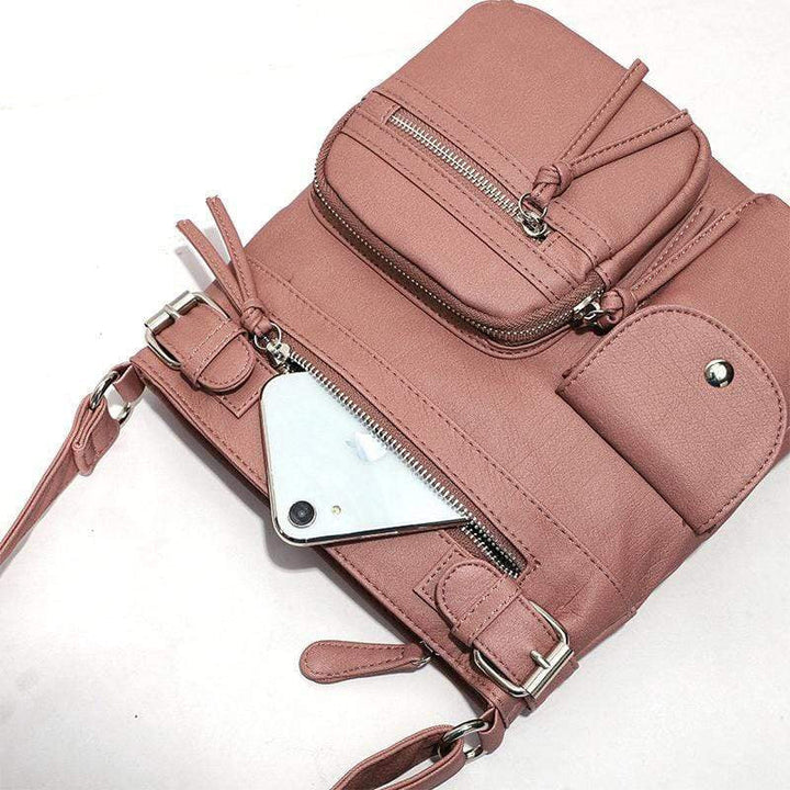 "Elegant damväska i veganskt läder, crossbody med flera fickor, vattentät och stilfull design för optimal organisation."