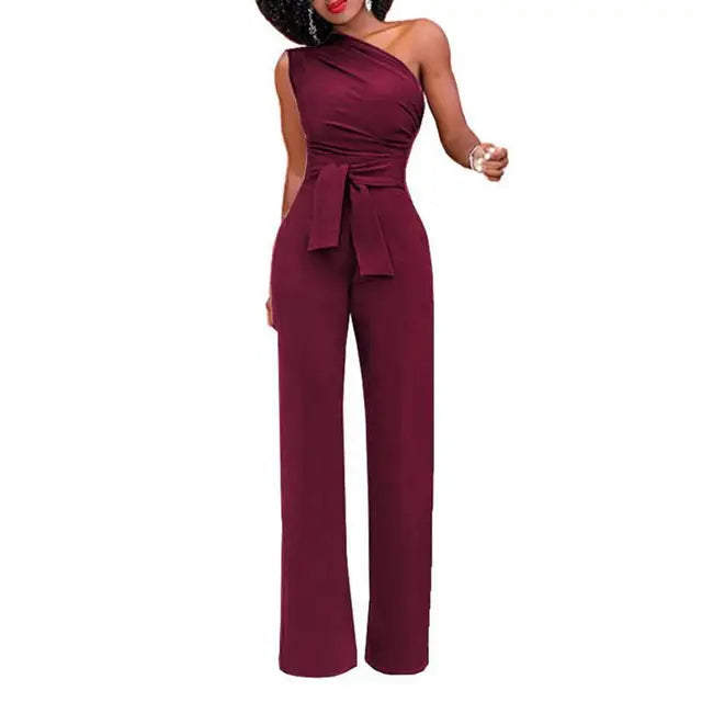 Phoebe damjumpsuit, enaxlad och elegant med knytmidja, perfekt för både fest och vardag.