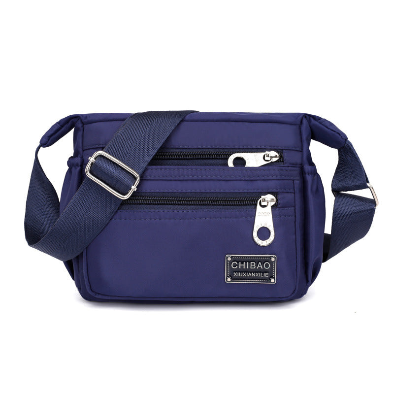 "Elegant flerlagers crossbodyväska i nylon för kvinnor, flera fack, vattentät, lämplig för mobiler och nycklar."
