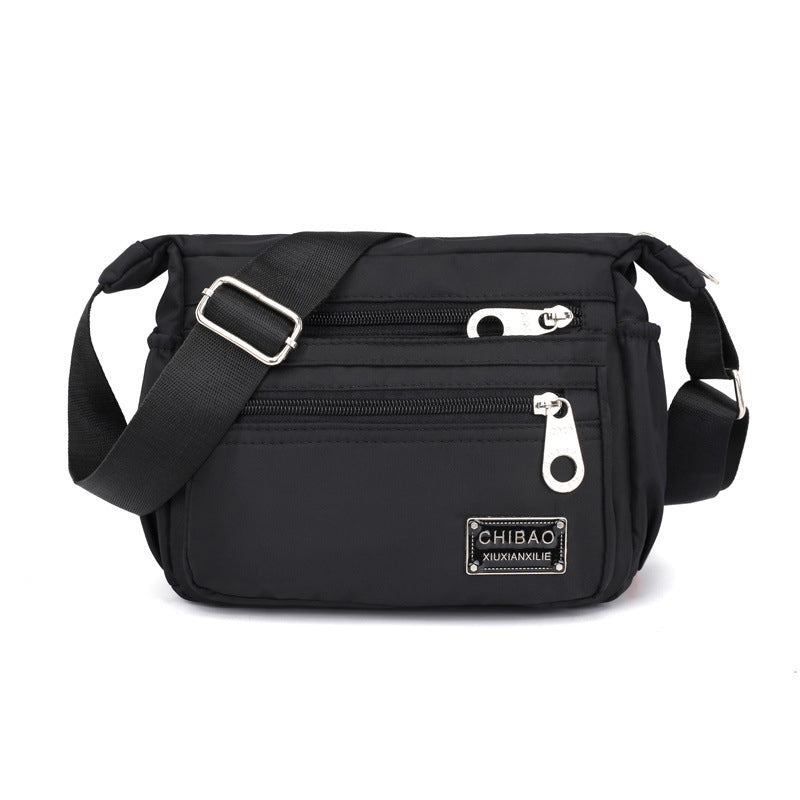 "Elegant flerlagers crossbodyväska i nylon för kvinnor, flera fack, vattentät, lämplig för mobiler och nycklar."