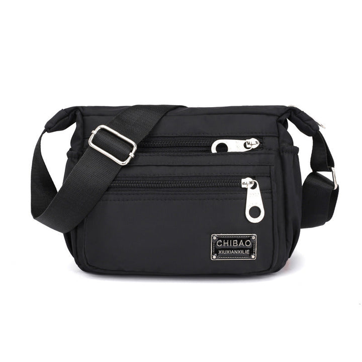 "Elegant flerlagers crossbodyväska i nylon för kvinnor, flera fack, vattentät, lämplig för mobiler och nycklar."