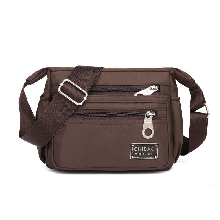 "Elegant flerlagers crossbodyväska i nylon för kvinnor, flera fack, vattentät, lämplig för mobiler och nycklar."