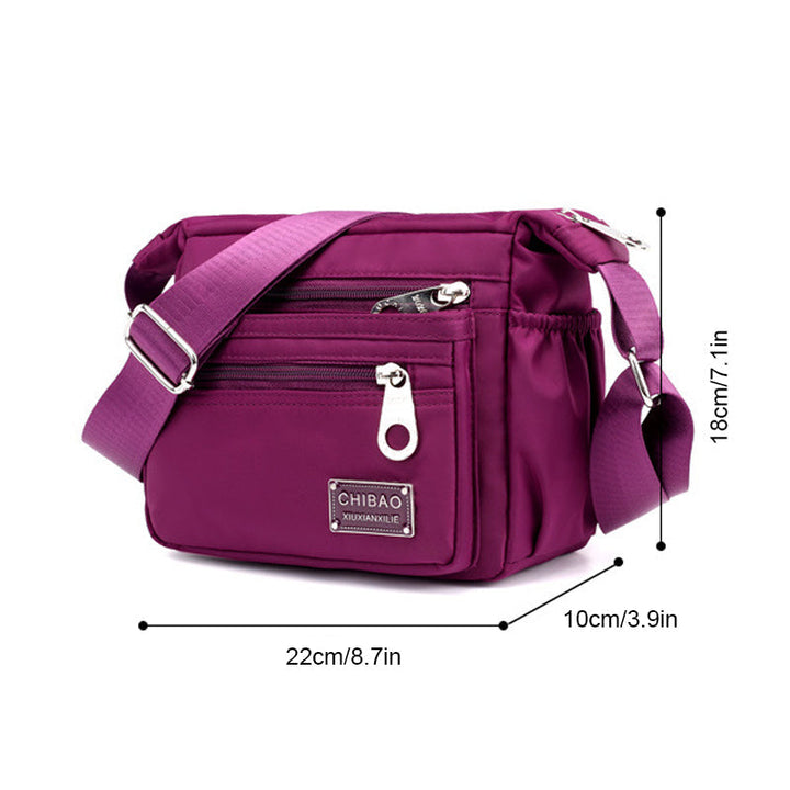 "Elegant flerlagers crossbodyväska i nylon för kvinnor, flera fack, vattentät, lämplig för mobiler och nycklar."