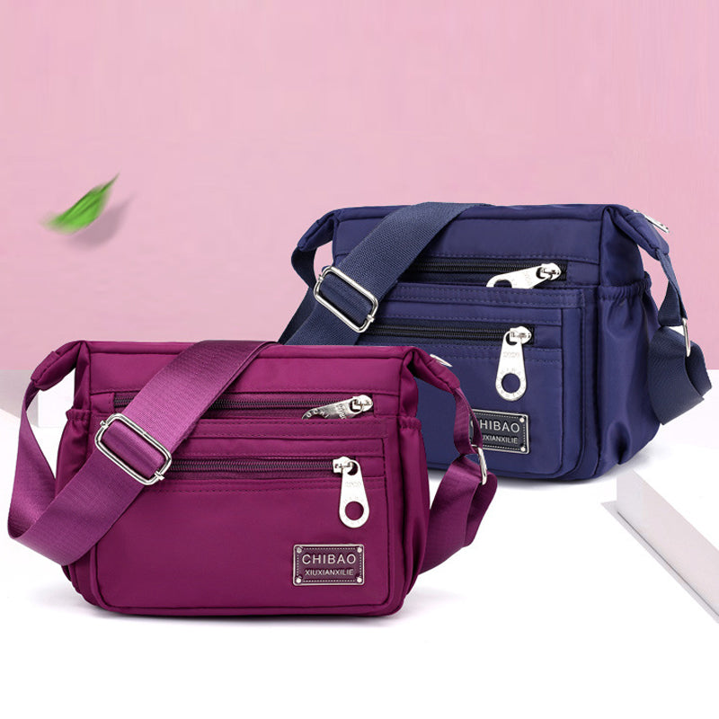 "Elegant flerlagers crossbodyväska i nylon för kvinnor, flera fack, vattentät, lämplig för mobiler och nycklar."