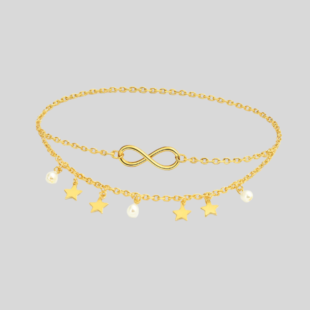 Elegant flerlagig damfotlänk med skimrande stjärnor och pärlor. Guld- eller silverfärg för stilfull accessoar.