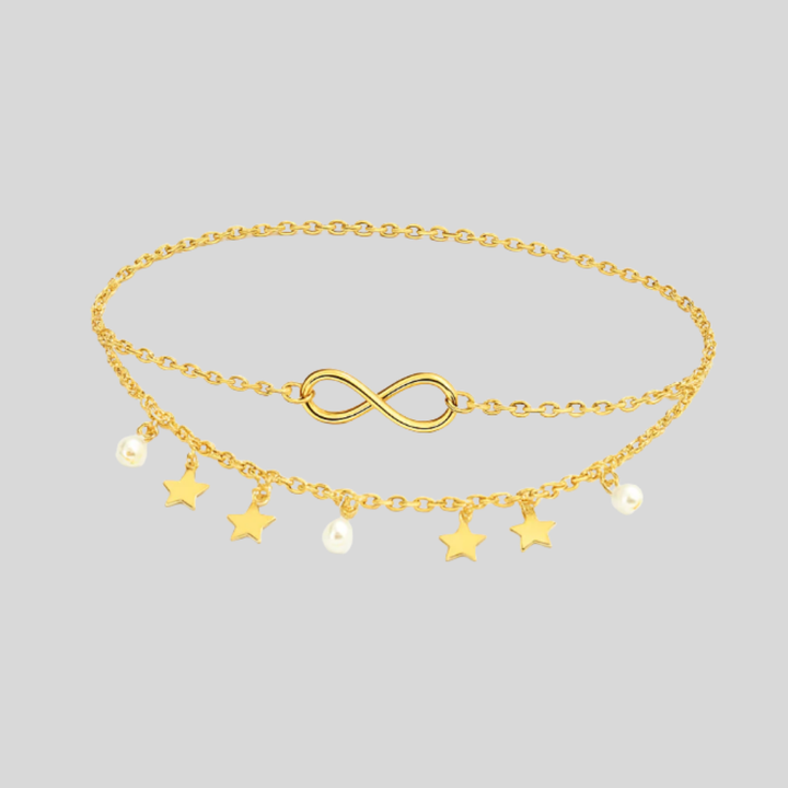 Elegant flerlagig damfotlänk med skimrande stjärnor och pärlor. Guld- eller silverfärg för stilfull accessoar.