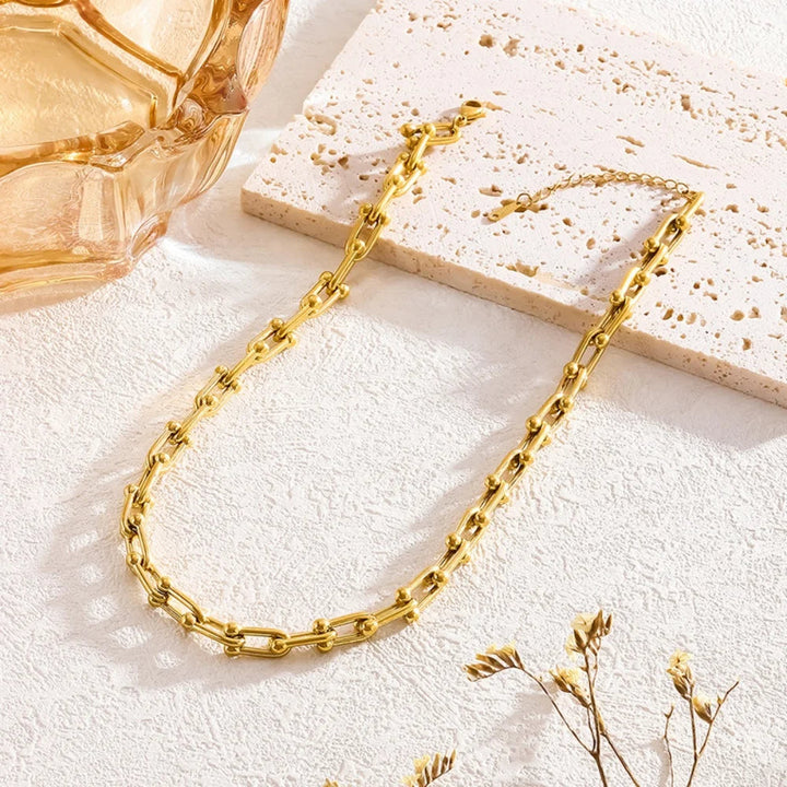 Vackert guld länkset för dam, en elegant presentidé med halsband och armband.