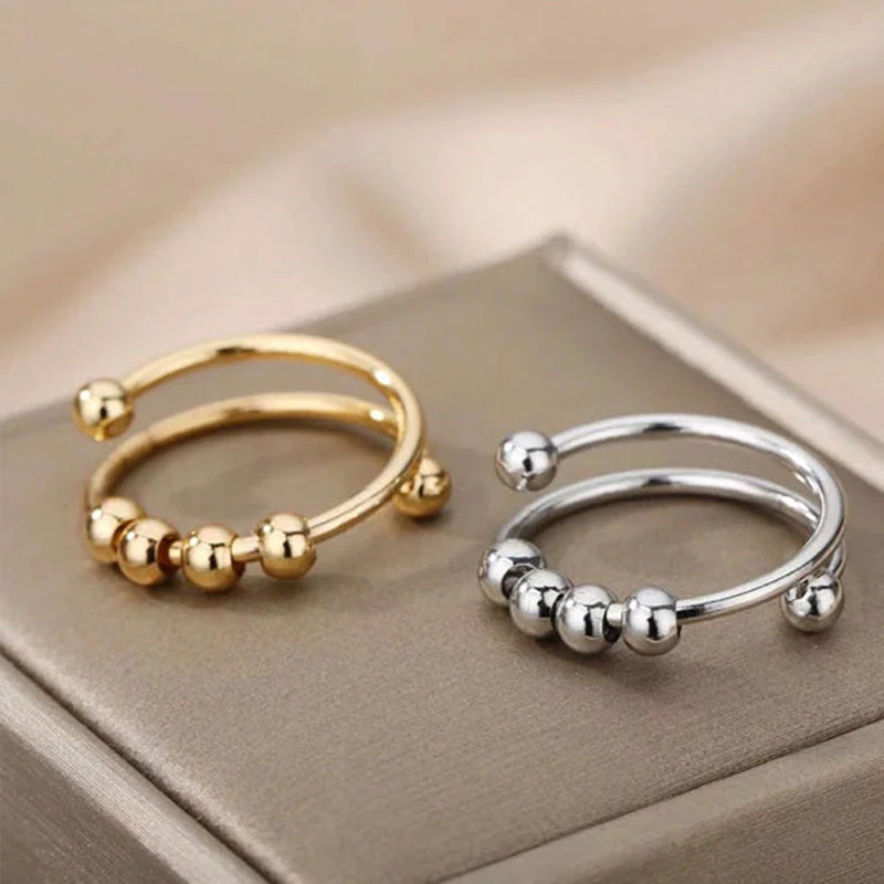 "Elegant justerbar ångestring med 4 roterbara metallpärlor för mindfulness och stresslindring, perfekt för kvinnors accessoar