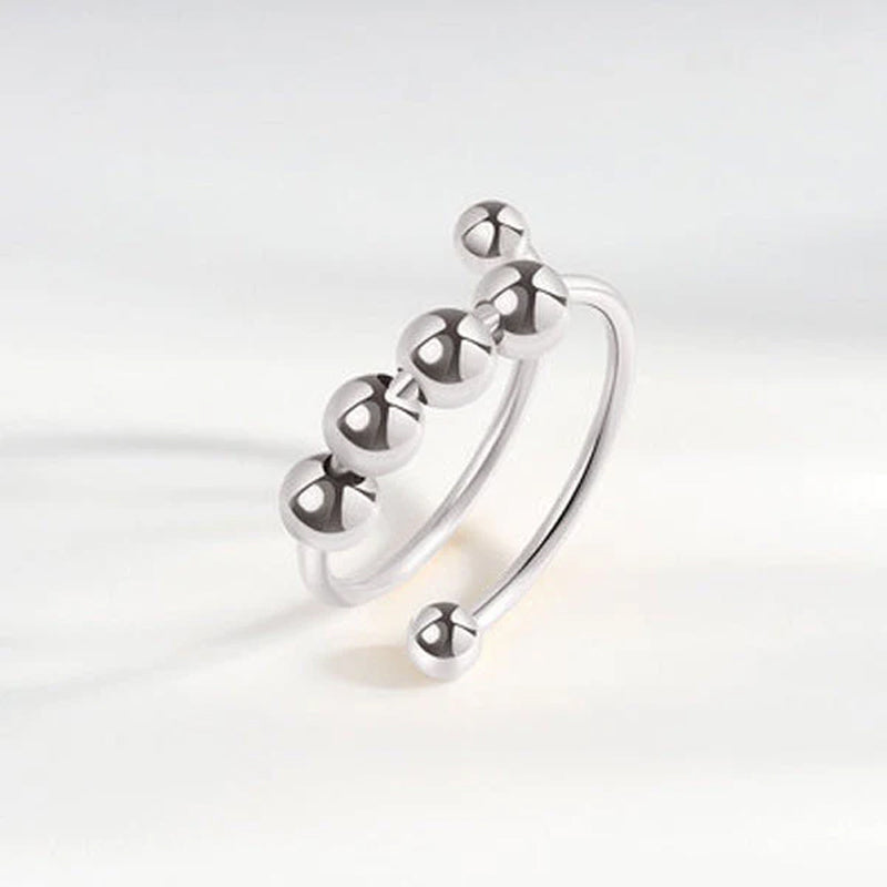 "Elegant justerbar ångestring med 4 roterbara metallpärlor för mindfulness och stresslindring, perfekt för kvinnors accessoar