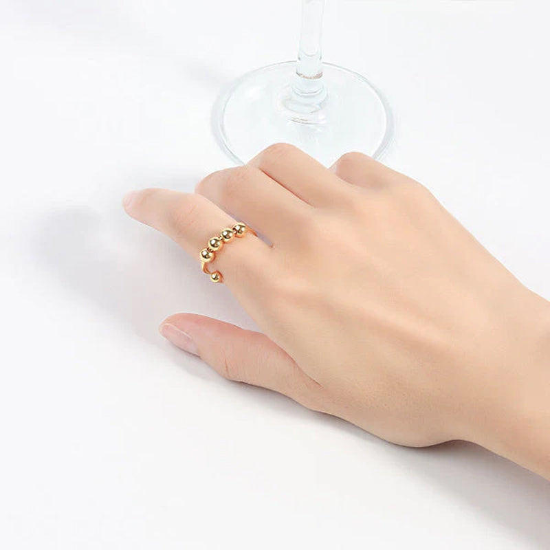"Elegant justerbar ångestring med 4 roterbara metallpärlor för mindfulness och stresslindring, perfekt för kvinnors accessoar