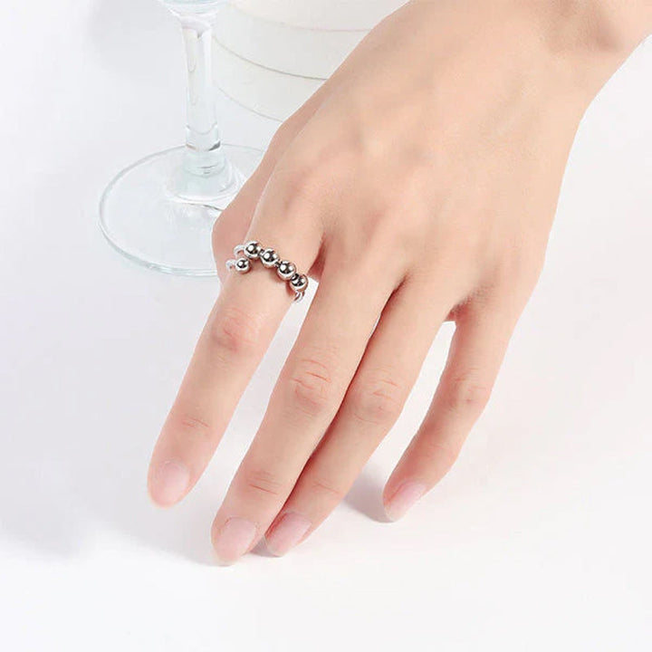 "Elegant justerbar ångestring med 4 roterbara metallpärlor för mindfulness och stresslindring, perfekt för kvinnors accessoar
