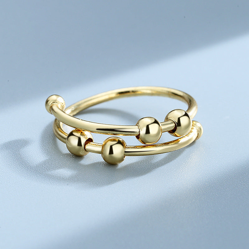 "Elegant justerbar ångestring med 4 roterbara metallpärlor för mindfulness och stresslindring, perfekt för kvinnors accessoar