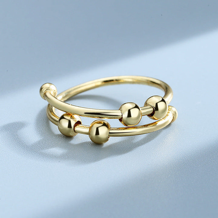"Elegant justerbar ångestring med 4 roterbara metallpärlor för mindfulness och stresslindring, perfekt för kvinnors accessoar