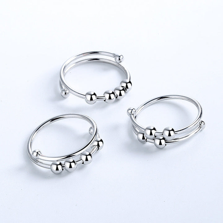 "Elegant justerbar ångestring med 4 roterbara metallpärlor för mindfulness och stresslindring, perfekt för kvinnors accessoar